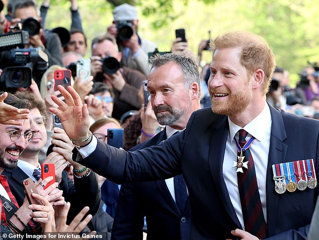 Prince Harry greets the public outside St Paul's Cathedral in London yesterday.