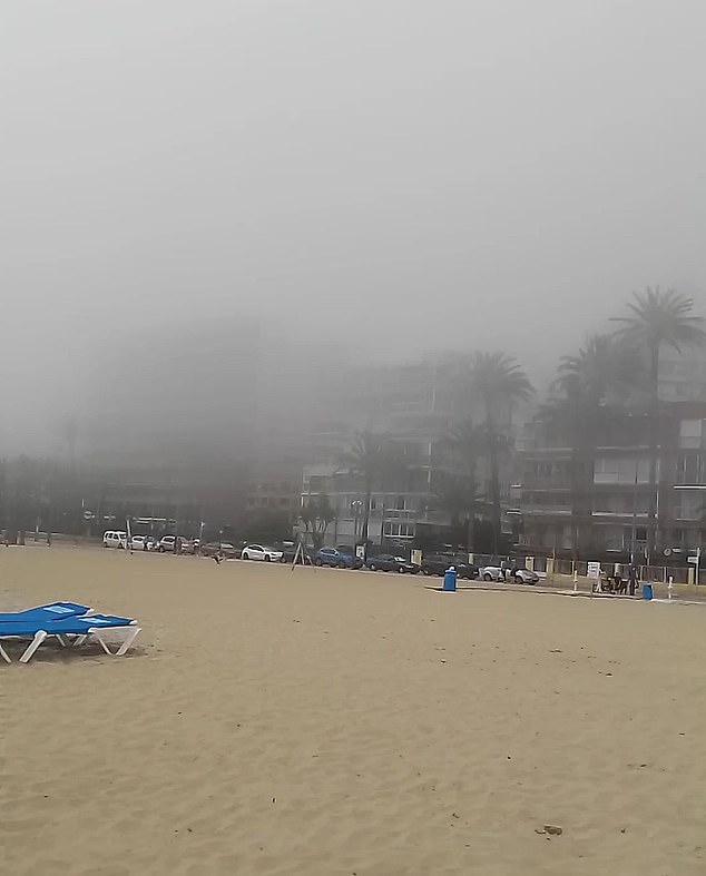 The 43-year-old assumed a fire had broken out in a nearby apartment, but decided to stay on the beach to film the spooky scene, unlike most other tourists who fled the strange phenomenon. He later learned that the fog was 