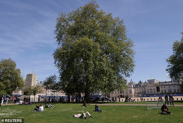 People enjoy the sunshine in St. James's Park in London, May 8, 2024