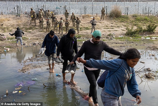 Migrants return to the Texas side of the Rio Grande Valley on April 20 after the Texas National Guard conducts an operation to disperse those in the Rio Grande Valley trying to request asylum.