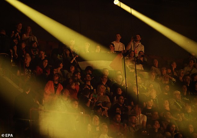 A Palestinian flag flies during Golan's performance of his song 'Hurricane' during the semi-final of the competition last night.