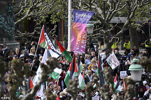 Protesters tear down a Eurovision flag during the demonstration 