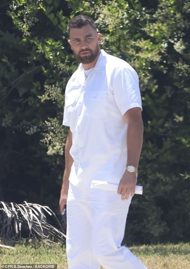 The NFL star and Taylor Swift's boyfriend, 34, sported an all-white ensemble and held a script as he walked to the set.