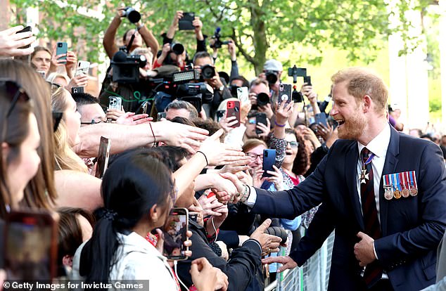 Prince Harry meets the public outside St Paul's Cathedral in London yesterday.