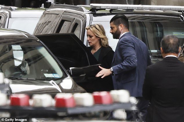 Daniels is seen leaving Manhattan criminal court after cross-examination ended.