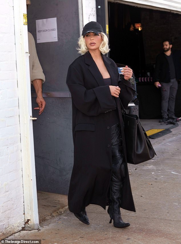 For her Thursday outfit, Kim wore her platinum-dyed blonde locks short and loose under her black baseball cap.