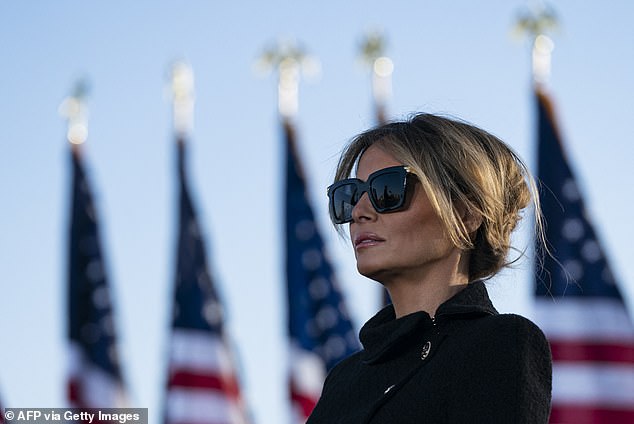 Melania Trump listens as her husband, outgoing US President Donald Trump, addresses guests at Joint Base Andrews in Maryland on January 20, 2021.