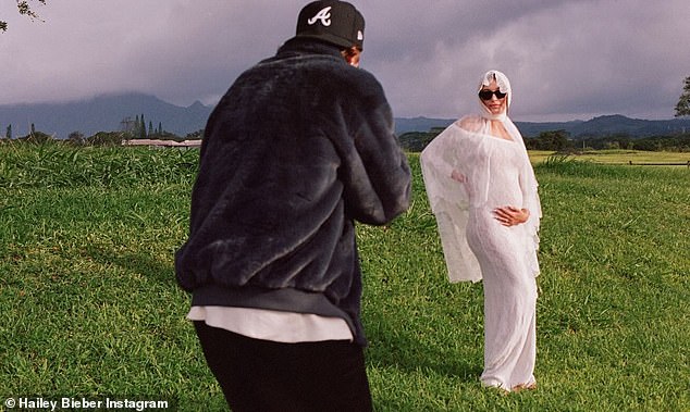 The model announced her baby joy with a beautiful video that shows her debuting her baby bump in a custom Saint Laurent lace wedding dress by Anthony Vaccarello, paired with a flowy veil during a surprise vow renewal in Hawaii.