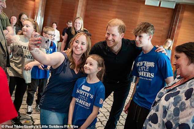 Harry looked in high spirits as he posed for selfies with people at the event.