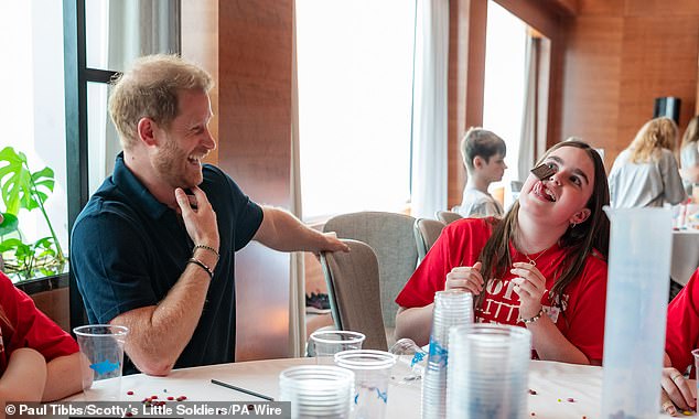 The Duke laughs at one of the girls who tries to remove a piece of chocolate from her face