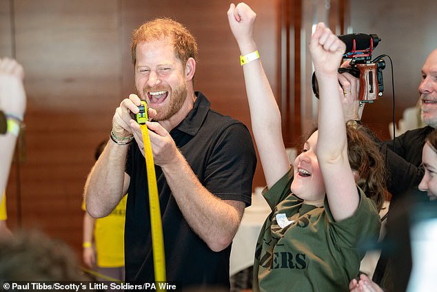 Harry was pictured enjoying games with children and young people from the charity on an unofficial visit.