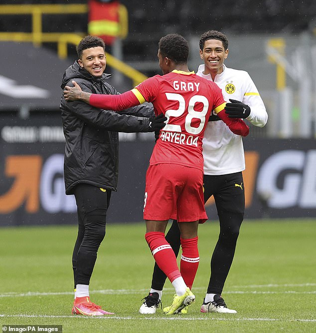 The pair greet fellow Englishman Demarai Gray during Dortmund's clash against Bayer Leverkusen in 2021. Gray, who like Bellingham is from Birmingham, now plays in Saudi Arabia.