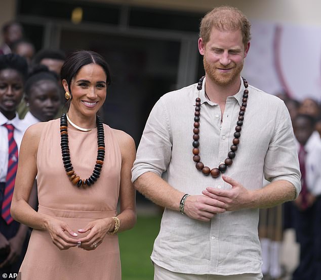 Meghan added a little more glamor by wearing Diana's gold Cartier Tank Française watch