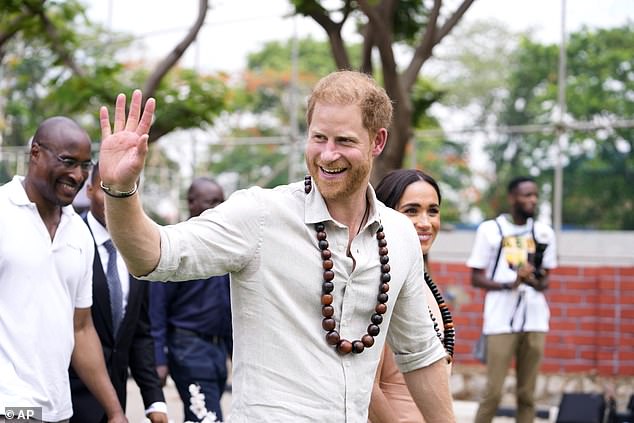 Prince Harry greets students as he arrives at Wuse Lightway Academy in Abuja today