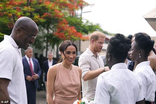 Harry and Meghan at the Wuse Lightway Academy in Abuja today as they talk to the children