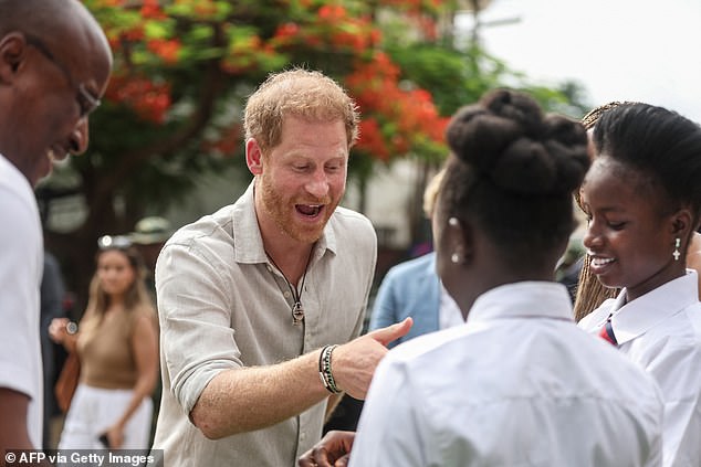 Prince Harry greets students as he arrives at Wuse Lightway Academy in Abuja today