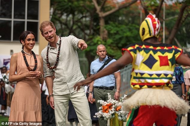 The Duke and Duchess watch dancers at the Wuse Lightway Academy in Abuja this morning.