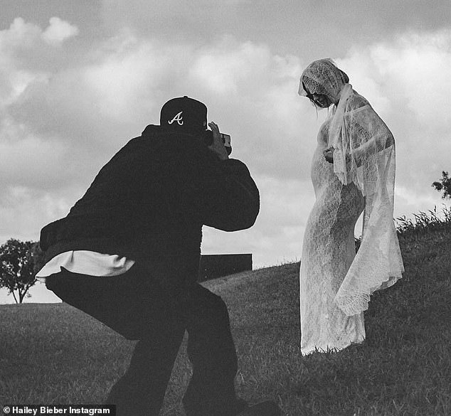 She debuted her baby bump in a custom Saint Laurent lace wedding dress by Anthony Vaccarello, paired with a flowy veil, during a surprise vow renewal in Hawaii.