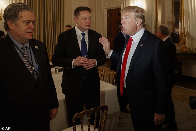 Bannon is seen in the State Dining Room of the White House in February 2017 with President Donald Trump and technology entrepreneur Elon Musk.