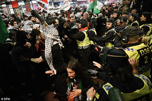 Police use pepper spray and fight against pro-Palestinian protesters in central Malmo during the 68th Eurovision Song Contest.