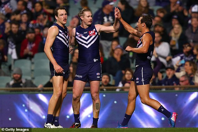 McCarthy (pictured center during a 2017 game for the Dockers) managed to transfer to his hometown club after beginning his AFL career with the GWS Giants.