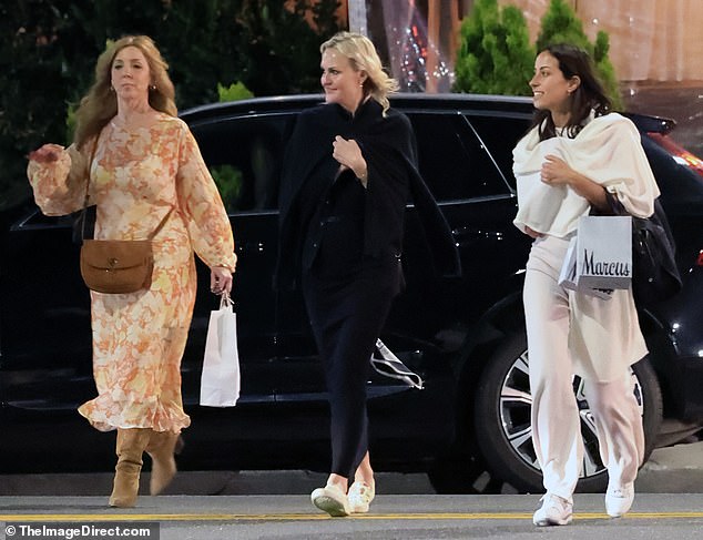 De Ramon was seen carrying a couple bags full of Neiman Marcus shopping, while one of her friends appeared to be bringing home some leftovers from dinner.