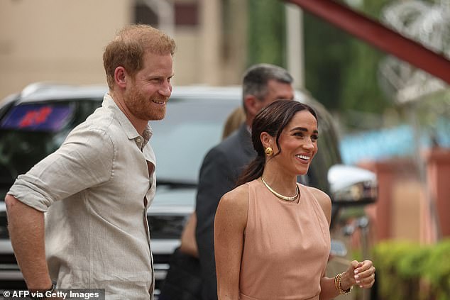 Prince Harry and Meghan Markle arrive at the Wuse Lightway Academy in Abuja on Friday morning.