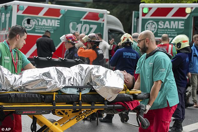 Paramedics transport injured travelers after two trains collided in Buenos Aires, Argentina, on Friday morning.