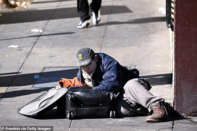 Despite criticism of allowing addiction, officials argue that it saves money by reducing the use of emergency services. In the photo, a homeless man is seen on the sidewalk.