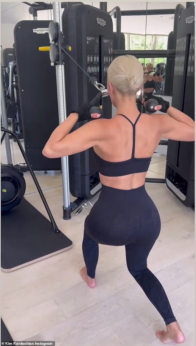 The billionaire SKIMS mogul showed off her flat abs in a sports bra and leggings