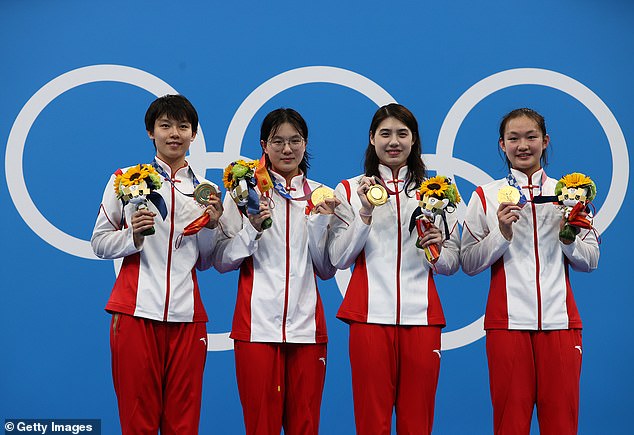 Chinese swimmers Junxuan Yang, Yufei Zhang, Bingjie Li and Muhan Tang pose with their gold medals at the Tokyo Games