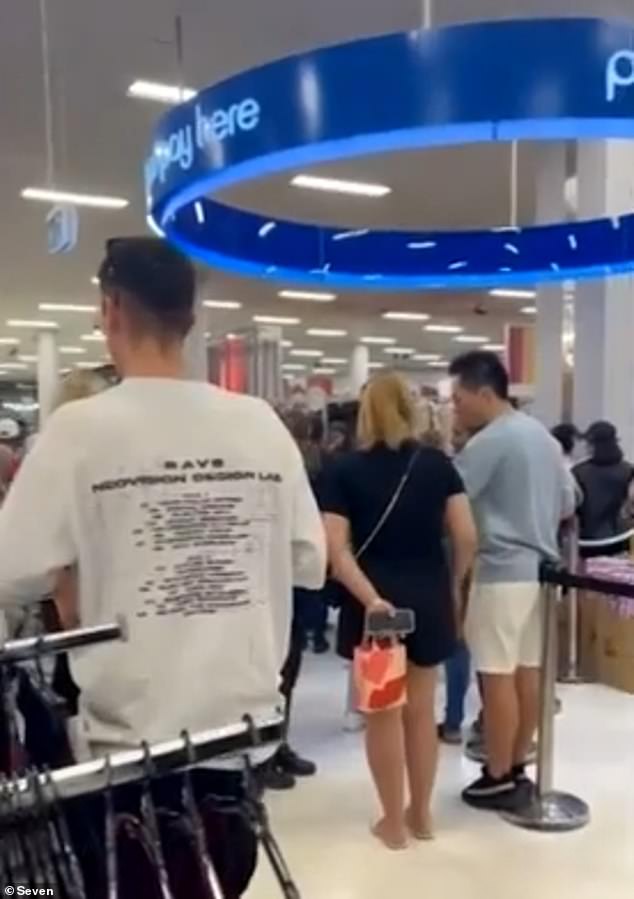 The chaos began when a fight broke out between two men, one of them armed with a knife, at the Westfield Carousel shopping center in the south-east of the city around 3.30pm on Friday (pictured, shoppers locked in Kmart) .