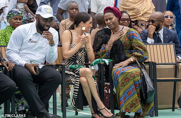 Meghan has earned the love of her hosts, with a group of fans holding signs saying 