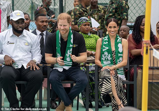 As he walked out onto the field to join Invictus board member David Wisey, Harry removed a green and white Nigerian scarf he had been gifted before enthusiastically joining in.