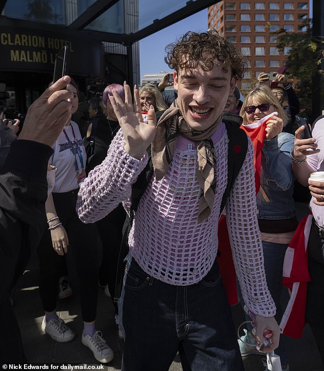 Nemo Mettler, 24, representing Switzerland, was surrounded by fans and protected by security as he left his hotel.