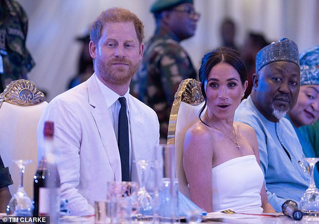 Prince Harry matched his wife with a white suit and navy tie for dinner