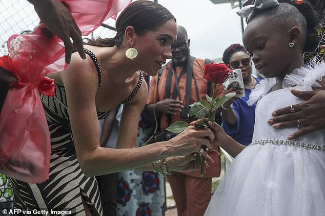 The Duchess of Sussex, 42, watched from the sidelines in Johanna Ortiz's Tropicana Nights dress, which features a palm leaf-style design in black and cream, with cutout details under the bust.