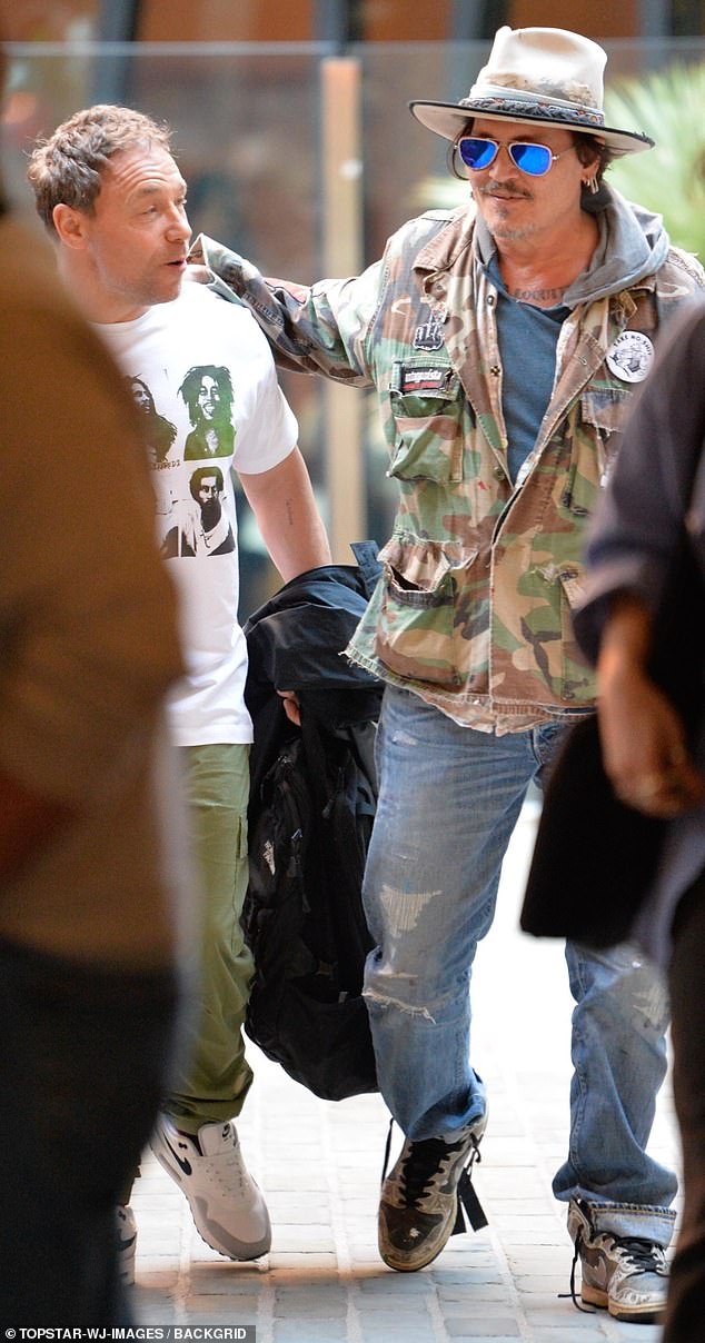 Johnny smiled in a camouflage jacket, a pair of sunglasses and a bucket hat, while Stephen Graham OBE wore a white Bob Marley-print t-shirt from DSQUARED2.