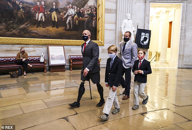 Mast walks with his sons Magnum and Maverick at the US Capitol during the pandemic