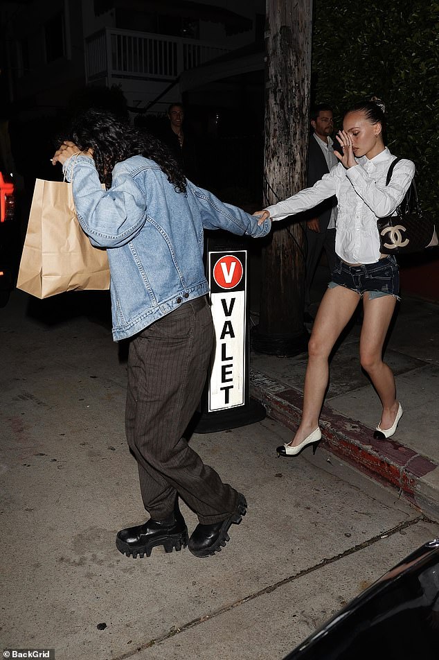 She accessorized her bold ensemble with a black quilted Chanel bag and white pumps with black tips.