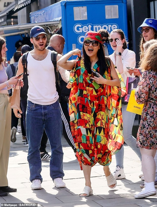 Elsewhere, Nancy, 32, turned heads in an oversized multi-color printed dress that she paired with her equally colorful scarf.