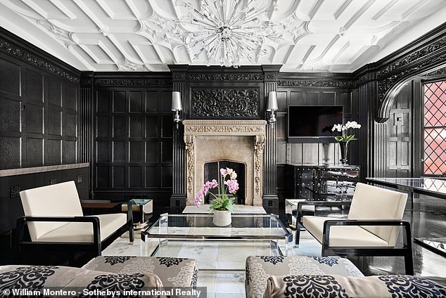 Black oak paneling gives the room a gothic feel.