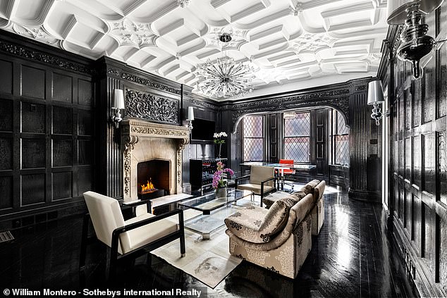 Glossy black varnished floors run through this reception room.