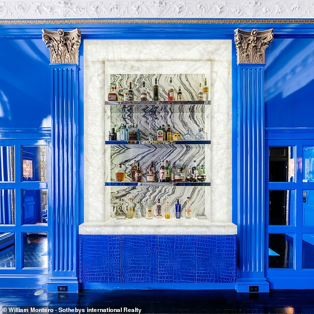 There are plenty of shelves for a fully stocked bar in the blue room.