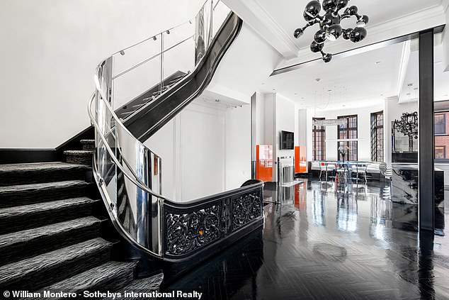 The zebra print rug can be seen on this flight of stairs leading from the kitchen area.