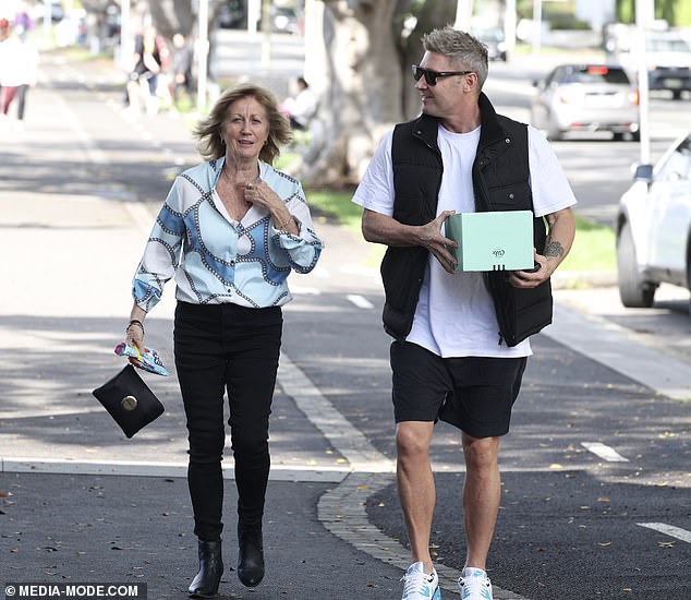 Michael opted for a relaxed ensemble, sporting black shorts, a white T-shirt and a black padded vest.