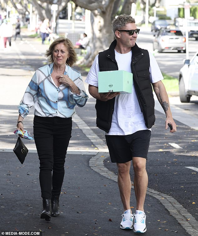 Debbie looked stylish in a vibrant blue top and plain black pants.