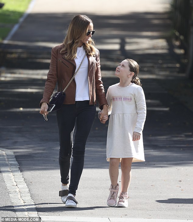 Kyly looked stylish in a sleek brown leather jacket paired with a white top and black pants. Pictured is her with her daughter Kelsey-Lee