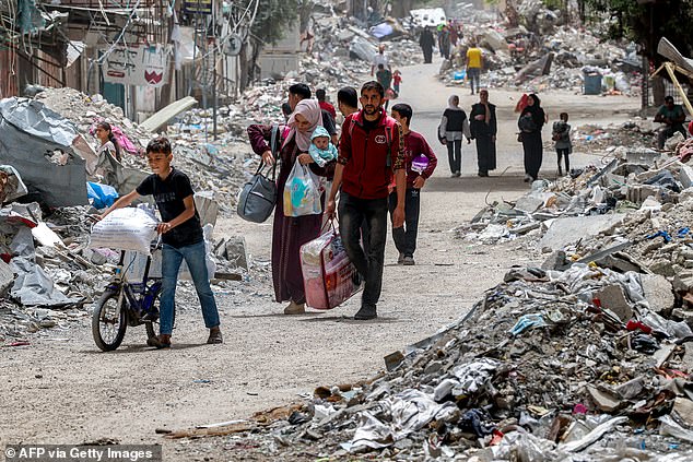 Displaced Palestinians are evacuated from the Tal al-Zaatar Palestinian refugee camp in the northern Gaza Strip on May 11, 2024