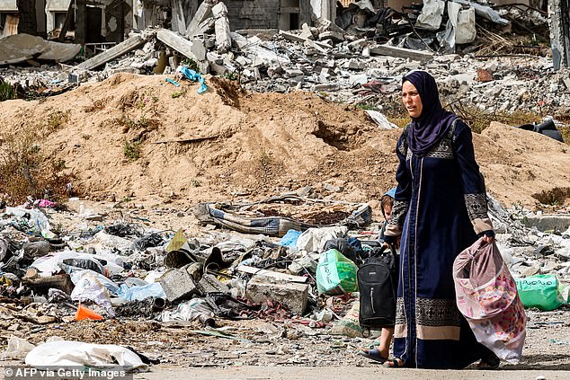 A woman and a child arrive on foot in the Daraj neighborhood of Gaza City on May 11, 2024.